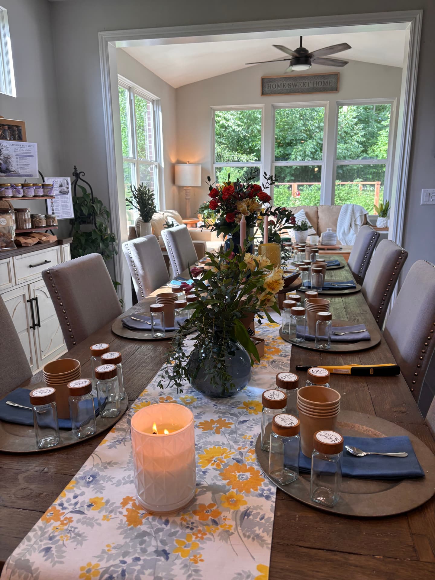 Cindy's workshop table set with a floral runner, flowers, candle and handmade salts for guests